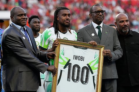 Officials present Nigeria's Alex Iwobi with a 100-cap plaque before an international friendly soccer match between Portugal and Nigeria in Leiria.
