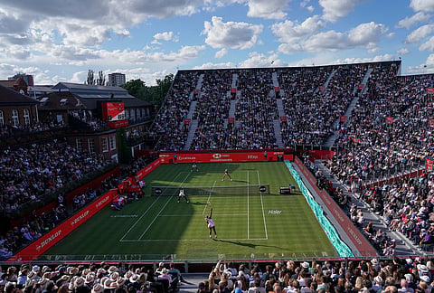 Serena Williams of the United States, bottom right, serves as she and playing partner Victoria Mboko of Canada play against Nicole Melichar-Martinez of Canada and Erin Routliffe of New Zealand during their first round doubles match at the Queen's Club tennis championships in London.