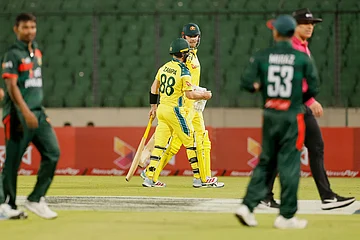 | Photo: AP/Mosaraf Hossain : Bangladesh and Australia's players leave the field after rain stopped play during the first one day international cricket match between Australia and Bangladesh in Mirpur, Bangladesh.