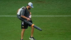 A groundskeeper uses a leaf blower to dry parts of the pitch after a heavy rain before an international friendly soccer match between Costa Rica and England. - AP Photo