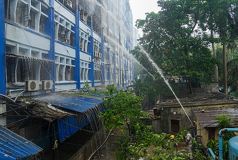 Firefighters attempt to douse a fire at a government building in the Alipore area, in Kolkata, West Bengal. 