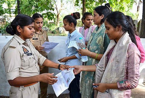 Aspirants undergo security checks before they are allowed to appear for the 'Uttar Pradesh Police constable recruitment examination', in Prayagraj, Uttar Pradesh.