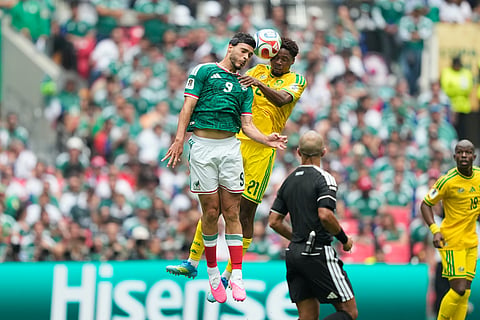 Mexico's Raul Jimenez, left, and South Africa's Ime Okon during the World Cup Group A soccer match between Mexico and South Africa in Mexico City, Thursday, June 11, 2026.