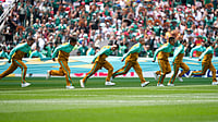 (AP Photo/Natacha Pisarenko) : Volunteers pull a tarp over the pitch before the start of the World Cup Group A soccer match between Mexico and South Africa in Mexico City, Thursday, June 11, 2026.
