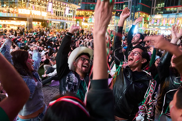 Fans react as they watch a broadcast of the FIFA World Cup 2026 match between Mexico and South Africa in Berlin, Germany, Thursday, June 11, 2026. - AP Photo/Ebrahim Noroozi
