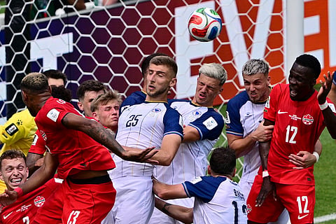 Bosnia's Tarik Muharemovic (4), center, heads away the ball during their FIFA World Cup 2026, Group B match against Canada in Toronto on Friday, June 12, 2026.