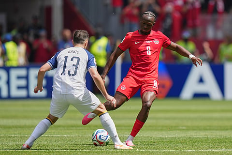 Bosnia's Ivan Basic, left, challenges Canada's Ismael Kone for the ball during the World Cup Group B soccer match between Canada and Bosnia in Toronto, Friday, June 12, 2026.