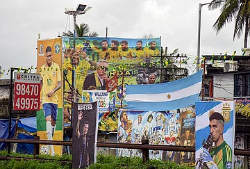 | Photo: PTI : Football fans of various clubs install large hoardings of Brazilian player Neymar Jr, Argentine players Lionel Messi and Emiliano Martínez, football manager Lionel Scaloni and other players ahead of the FIFA World Cup, at Kochi, in Ernakulam district, Kerala.