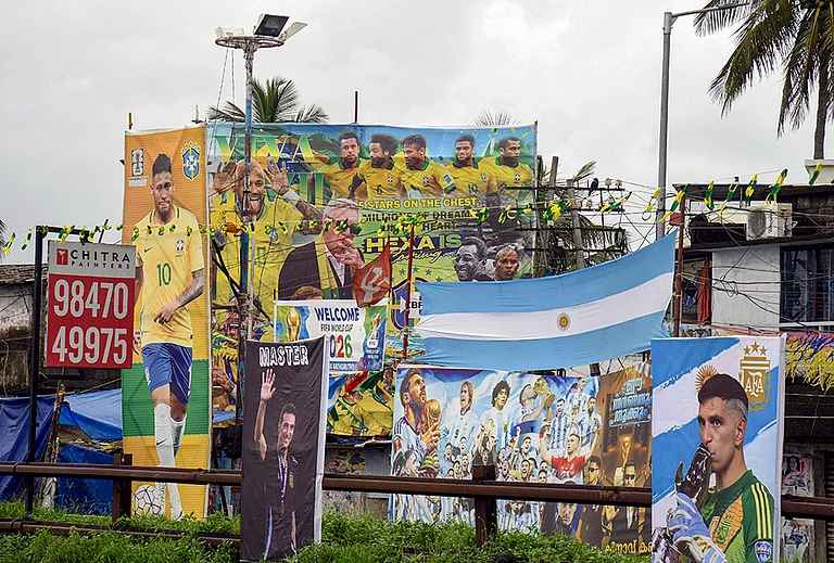 Football fans of various clubs install large hoardings of Brazilian player Neymar Jr, Argentine players Lionel Messi and Emiliano Martínez, football manager Lionel Scaloni and other players ahead of the FIFA World Cup, at Kochi, in Ernakulam district, Kerala. - | Photo: PTI