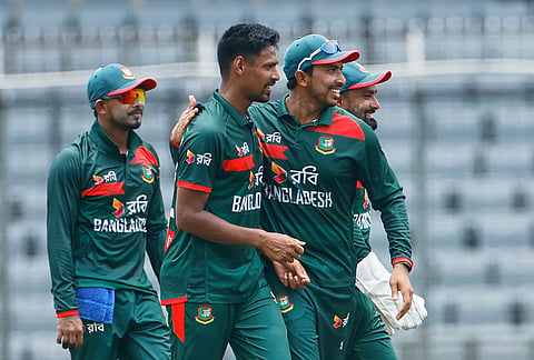 Bangladesh's Mustafizur Rahman, center, celebrates with teammates the wicket of Australia's Alex Carey during the second one day international cricket match between Australia and Bangladesh in Mirpur, Bangladesh.