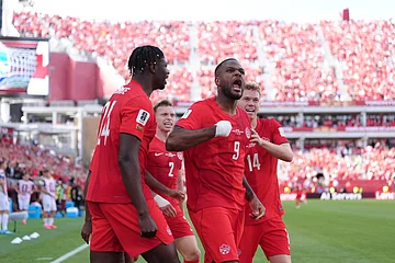 AP Photo/Sam Balkansky : Canada's Cyle Larin (9) celebrates with teammates after scoring a game-tying goal during their FIFA World Cup 2026, Group B match in Toronto on Friday, June 12, 2026. The match ended 1-1.