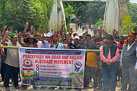 | Photo: PTI : Surrendered members of the National Liberation Front of Tripura (NLFT) and All Tripura Tiger Force (ATTF) block a national highway in protest at Baramura area, near Agartala, Tripura.