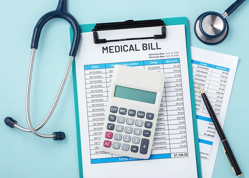 Medical bill on a clipboard with a stethoscope, calculator, and pen on a blue background