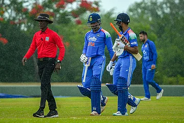 | Photo: SLC via PTI : In this image received on June 11, 2026, India's captain Tilak Varma and others return to the pavilion amid rainfall during an ODI cricket match between India-A and Afghanistan-A, in Dambulla, Sri Lanka.