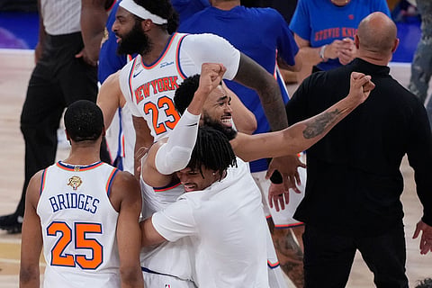 New York Knicks center Karl-Anthony Towns celebrates with guard Mikal Bridges (25) and enter Mitchell Robinson (23) after Game 4 of the NBA Finals basketball series against the San Antonio Spurs in New York.