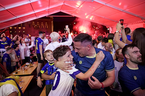 Bosnian fans celebrate at a fan festival, Friday, June 12, 2026, in Sarajevo, Bosnia, after Bosnia scored the opening goal as they watch a broadcast of the World Cup Group B soccer match between Canada and Bosnia. 