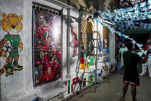Football fans decorate a street with flags and murals ahead of the FIFA World Cup 2026, in Kolkata. 