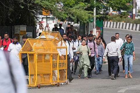 Commuters walk through Bandra-Kurla Complex (BKC) during the 'Weekly Public Transport Day' campaign amid concerns over long walking distances, humid weather and inadequate last-mile connectivity for public transport users, in Mumbai, Maharashtra. The Mumbai Metropolitan Region Development Authority (MMRDA), in collaboration with WRI India, launched the campaign aiming to reduce traffic congestion, curb pollution and promote sustainable mobility in the commercial hub.