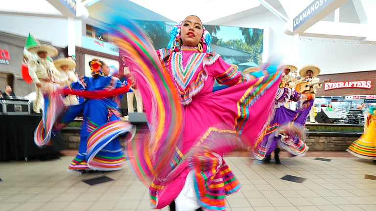 Sara Contreras dances with members of Ballet FolklÛrico Azteca of Fort Worth during a FIFA World Cup soccer tournament opening match watch party, Thursday, June 11, 2026, in Fort Worth, Texas. - (AP Photo/Julio Cortez)