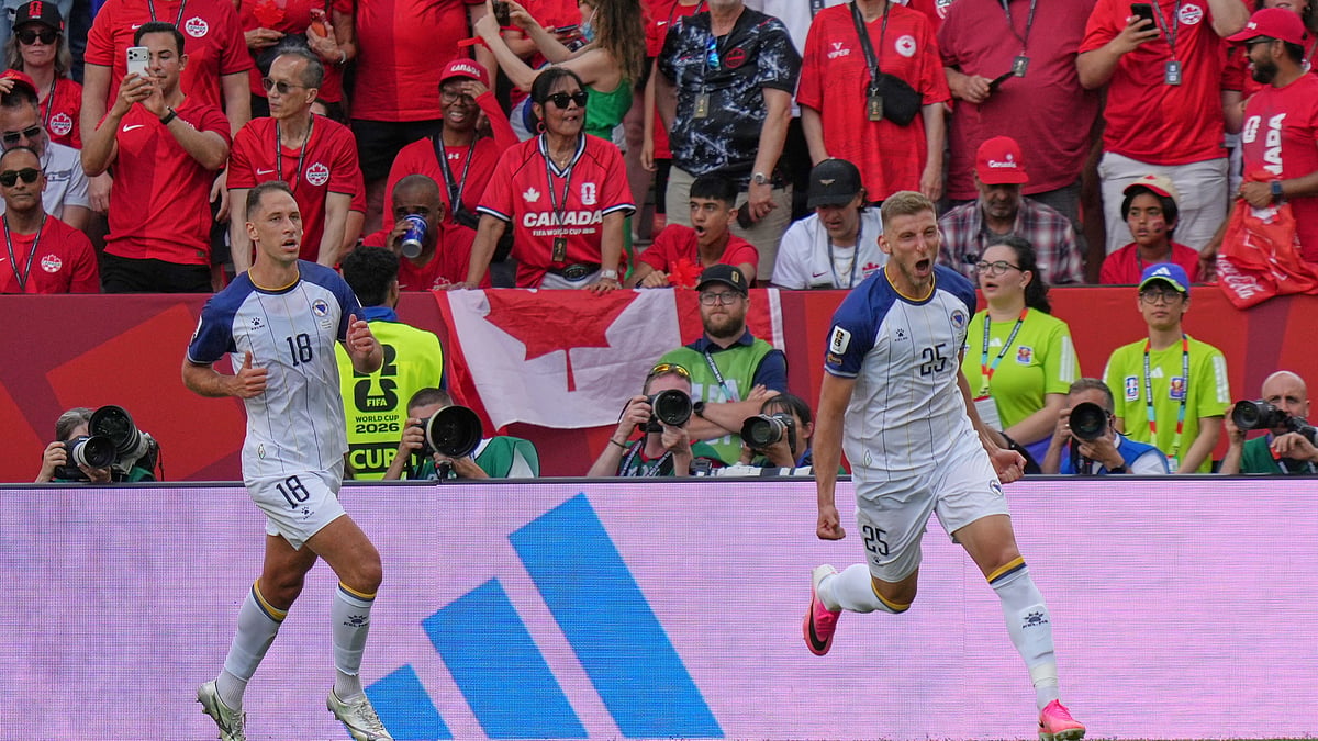 Bosnia's Jovo Lukic, right, celebrates after he scores the opening goal during the World Cup Group B soccer match between Canada and Bosnia in Toronto, Friday, June 12, 2026. - (AP Photo/Stephanie Scarbrough)