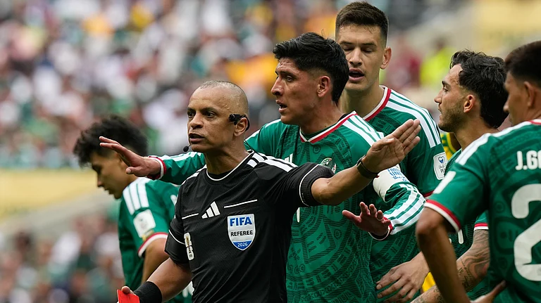 Mexican players complain to referee Wilton Sampaio, of Brazil, after he showed the red card Mexico's Cesar Montes during the World Cup Group A soccer match between Mexico and South Africa in Mexico City, Thursday, June 11, 2026. - AP Photo/Fernando Llano