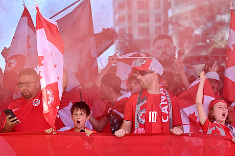 Members of the Voyageurs, Canada’s national team supporters, march toward Toronto Stadium ahead the World Cup Group B soccer match
