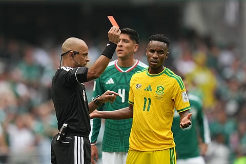 Referee Wilton Sampaio, of Brazil, show the red card to South Africa's Themba Zwane during the World Cup Group A soccer match between Mexico and South Africa in Mexico City, Thursday, June 11, 2026