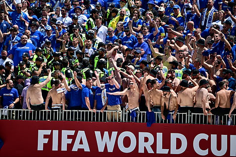 Toronto Police officers interact with Bosnia fans in the stands before the World Cup Group B soccer match between Canada and Bosnia, Friday, June 12, 2026, in Toronto. 