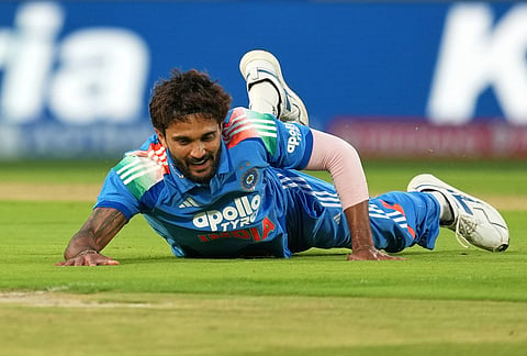 India's Nitish Kumar Reddy dives to field the ball during the first ODI cricket match between Afghanistan and India in Dharamshala.