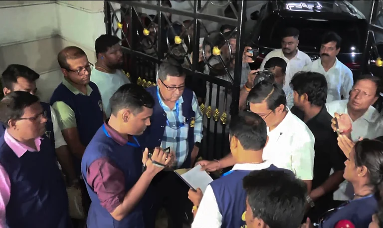 In this screengrab from a video posted on June 12, 2026, Crime Investigation Department (CID) officials serve a notice outside the residence of TMC leader Abhishek Banerjee in connection with an investigation of an alleged provocative statement made by him during a poll rally in West Bengal. - PTI