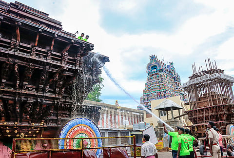 Firefighters clean the temple with water jets ahead of the annual car festival at Nellaiappar Temple, in Tirunelveli, Tamil Nadu.