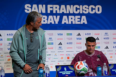 Switzerland head coach Murat Yakin, left, and captain Granit Xhaka, right, attend a news conference Friday, June, 12, 2026, in Santa Clara, Calif., ahead of the World Cup Group B soccer match between Switzerland and Qatar.