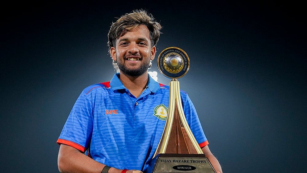 Vidarbha's captain Harsh Dubey poses with the trophy after Vidarbha won the Vijay Hazare Trophy 2025-26, at BCCI Centre of Excellence, in Bengaluru, Karnataka. - | Photo: PTI/Shailendra Bhojak