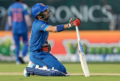 Afghanistan's Rahmanullah Gurbaz reacts after diving to make his criz during the first ODI cricket match between Afghanistan and India in Dharamshala.