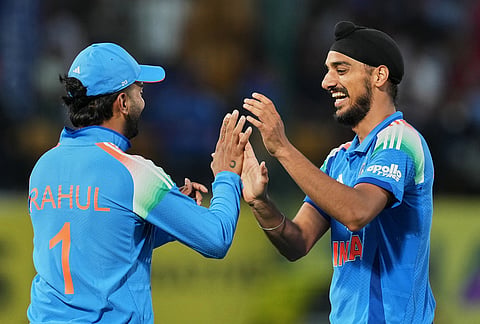 India's Arshdeep Singh, right, and KL Rahul celebrate the wicket of Afghanistan's captain Hashmatullah Shahidi during the first ODI cricket match between Afghanistan and India in Dharamshala.