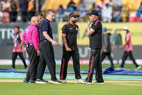 Afghanistan's captain Hashmatullah Shahidi, Umpires Chris Gaffaney, Virender Sharma and Rohan Pandit and others inspect the pitch after rain stopped, before an ODI cricket match between India and Afghanistan, in Dharamshala, Himachal Pradesh.