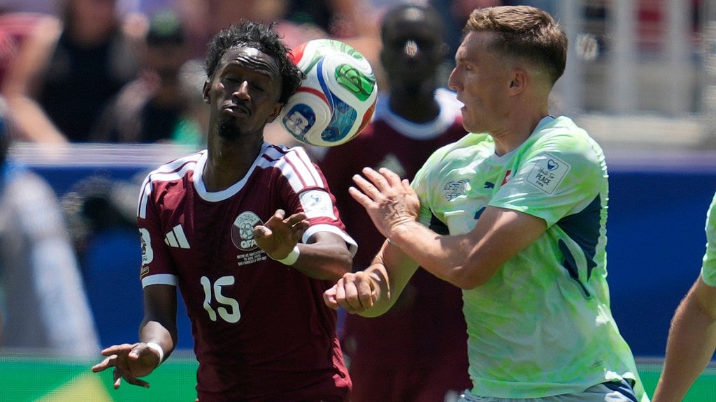 Qatar's Yusuf Abdurisag, left, and Switzerland's Michel Aebischer fight for the ball during the World Cup Group B soccer match between Qatar and Switzerland in Santa Clara. - AP Photo