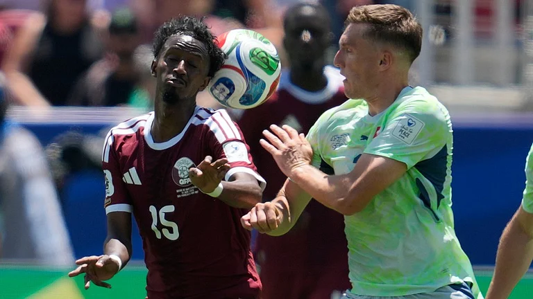 Qatar's Yusuf Abdurisag, left, and Switzerland's Michel Aebischer fight for the ball during the World Cup Group B soccer match between Qatar and Switzerland in Santa Clara. - AP Photo