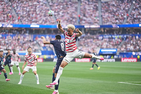 United States' Antonee Robinson, right, and Paraguay's Diego Gomez fight for the ball during the World Cup Group D soccer match between the United States and Paraguay in Inglewood, Calif., near Los Angeles, Friday, June 12, 2026.