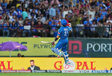 Afghanistan's Rahmanullah Gurbaz celebrates his century during the first ODI cricket match between Afghanistan and India in Dharamshala.