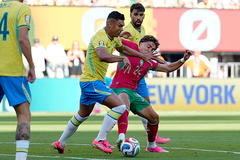 Brazil's Casemiro, left, challenges for the ball with Morocco's Neil El Aynaoui (24) during the World Cup Group C soccer match between Brazil and Morocco in East Rutherford, N.J., near New York, Saturday, June 13, 2026.