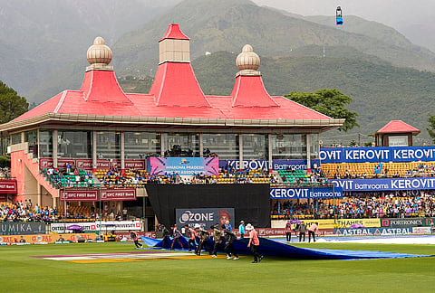 Ground staff remove covers from the field as rain stops, before an ODI cricket match between India and Afghanistan, in Dharamshala, Himachal Pradesh.