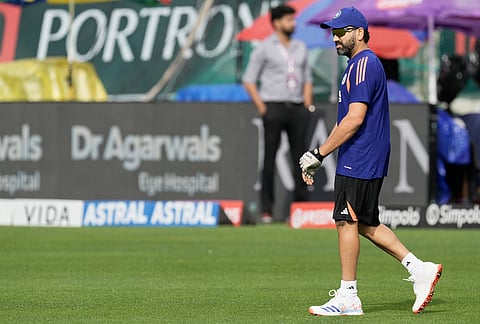 India's Rohit Sharma walks into to ground before the start of the first ODI cricket match between Afghanistan and India in Dharamshala.