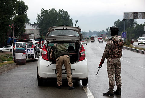 Security personnel inspect a vehicle along the Jammu-Srinagar National Highway ahead of the annual Amarnath Yatra, near Khanabal in Anantnag district, Jammu and Kashmir.