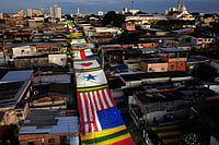 AP Photo/Edmar Barros : A decorated street is seen at dawn as residents prepare to watch the World Cup match between Brazil and Morocco in Manaus, Brazil, Saturday, June 13, 2026.