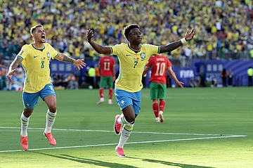 AP Photo/Adam Hunger : Brazil's Vinicius Junior (7) celebrates a goal in the first half during the World Cup Group C soccer match between Brazil and Morocco in East Rutherford, N.J., near New York, Saturday, June 13, 2026.