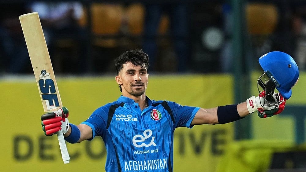 Afghanistan's Rahmanullah Gurbaz celebrates his century during the first ODI cricket match between Afghanistan and India in Dharamshala. - | Photo: AP/Ashwini Bhatia