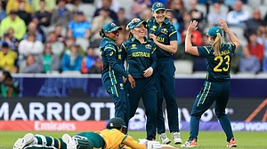 (Nigel French/PA via AP) : Australia's Georgia Wareham, center, celebrates with teammates after running out South Africa's Marizanne Kapp, on the ground, during the Women's T20 World Cup match between Australia and South Africa at Old Trafford, Manchester, England, Saturday June 13, 2026.