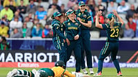 (Nigel French/PA via AP) : Australia's Georgia Wareham, center, celebrates with teammates after running out South Africa's Marizanne Kapp, on the ground, during the Women's T20 World Cup match between Australia and South Africa at Old Trafford, Manchester, England, Saturday June 13, 2026. 