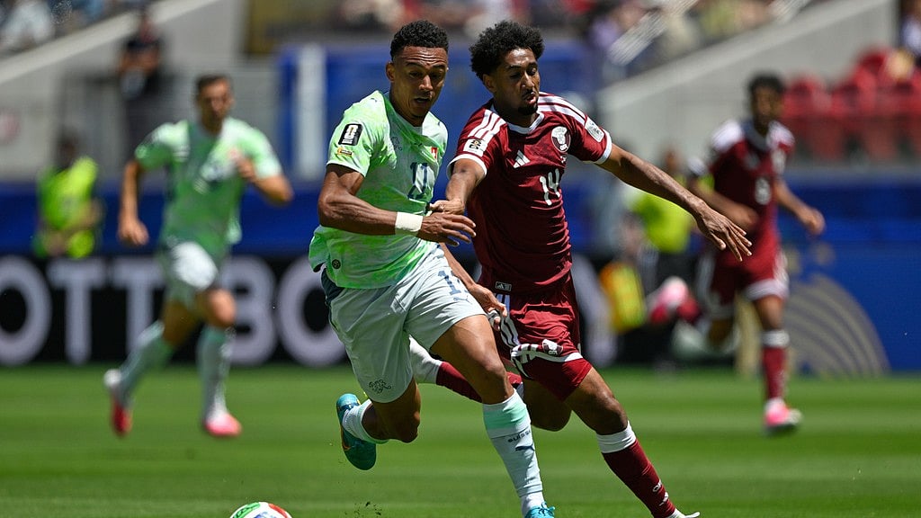 Switzerland's Dan Ndoye , left vies for the ball with Qatar's Homam Ahmed, during the World Cup Group B soccer match between Qatar and Switzerland in Santa Clara. - AP Photo
